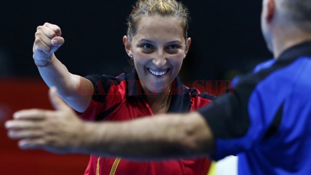 Romania's Elizabeta Samara celebrates with her coach V. Filimon after winning her women's singles third round table tennis match against Hong Kong's Tie Yana in the ExCel venue during the London 2012 Olympic Games