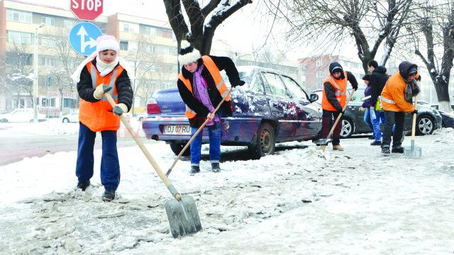Angajații de la Salubritate înlătură zăpada de pe trotuarele bulevardului 1 Mai (Foto: Bogdan Grosu)