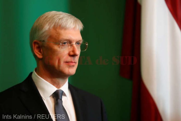 Prime Minister candidate Krisjanis Karins listens to the media in Riga