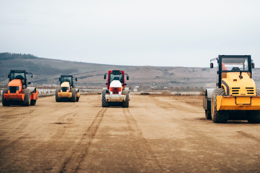 vibratory-compactor-during-road-and-highway-constr-2022-02-02-03-48-58-utc-scaled Se fac investiții în fabrici și uzine, se construiesc noi cartiere rezidențiale, zeci de noi kilometri de autostrăzi