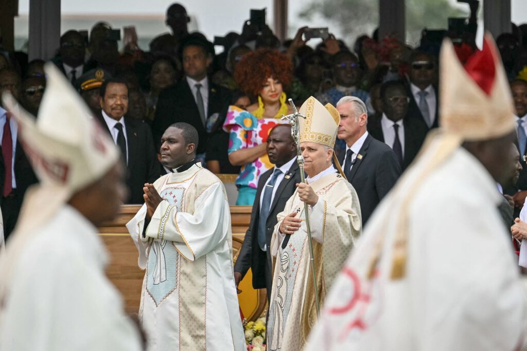Președintele Camerunului, Paul Biya, și prima doamnă a Camerunului, Chantal Biya, îl privesc pe Papa Leon al XIV-lea (C) sosind pentru a conduce Sfânta Liturghie pe Aeroportul Yaounde Ville din Yaounde, în a șasea zi a unei călătorii apostolice de 11 zile în Africa, pe 18 aprilie 2026